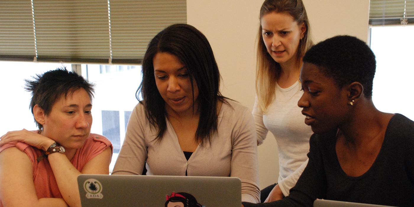 Four women working on a laptop